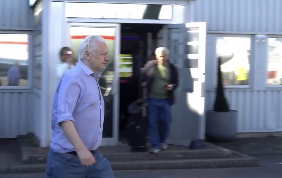 Julian Assange, camina para bordar un avión, en el aeropuerto London Stanstead después de haber sido liberado. Foto: Especial